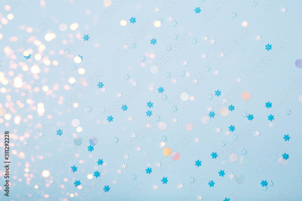 Little snowflakes confetti on blue background Little snowflakes confetti on blue background