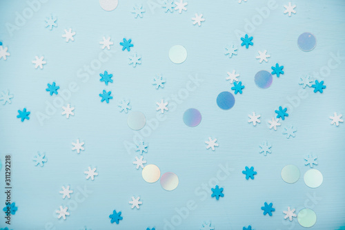 Little snowflakes confetti on blue background