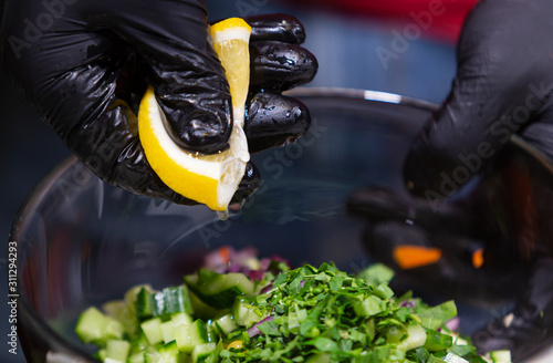 Lemon dressing. Home kitchen. Chef knife. Fresh lemon juice. Vegetable salad.