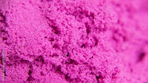 A close-up of pink kinetic sand. Macro shot
