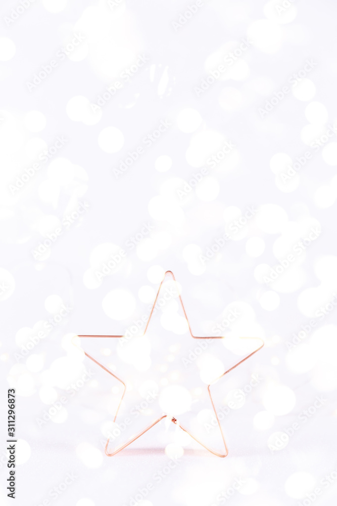 Star Copper cookie cutter on white sparkling background with bokeh lights. Holiday Christmas and New Year background. Vertical with festive bokeh lights Star Copper cookie cutter on white sparkling background with bokeh lights. Holiday Christmas and New Year background. Vertical with festive bokeh lights