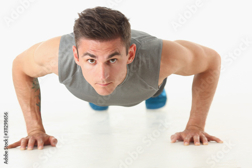 Fitness man wringing from the floor demonstrates