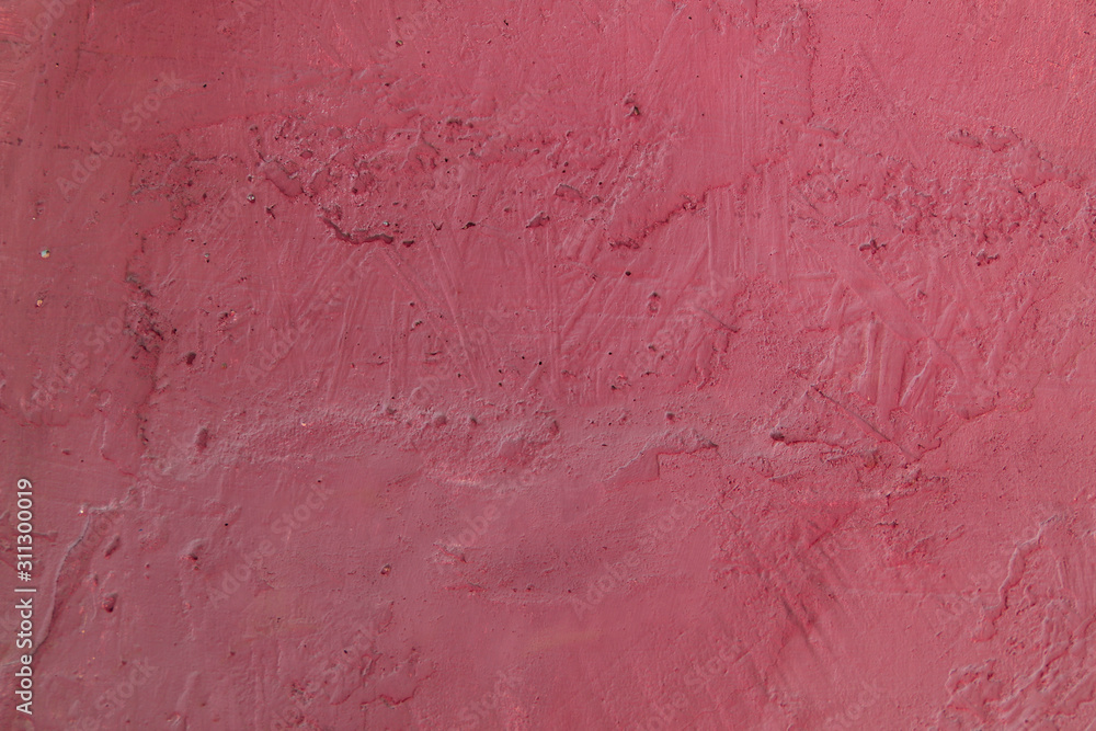 Blurred dark pink background. Cement surface with cracks and scratches painted with pink paint. Close-up, top view, horizontal, plenty of free space for text.