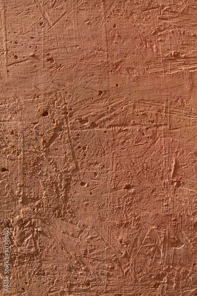 Brown background. A cement surface with cracks and scratches painted with brown paint. Close-up, top view, vertical, plenty of free space for text.