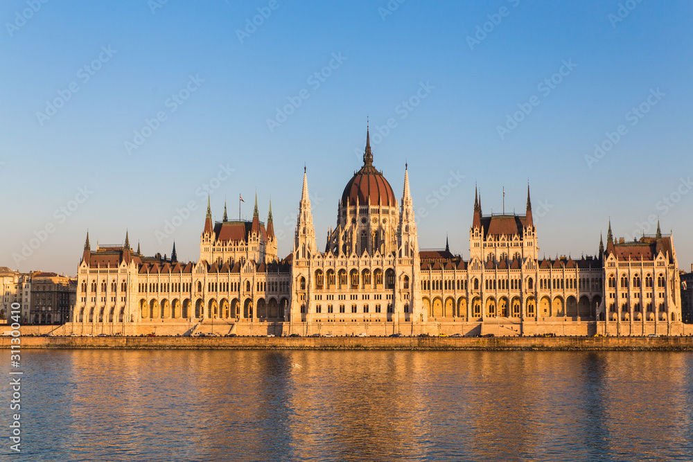 Budapest parliament building during sunset with reflection in Danube river