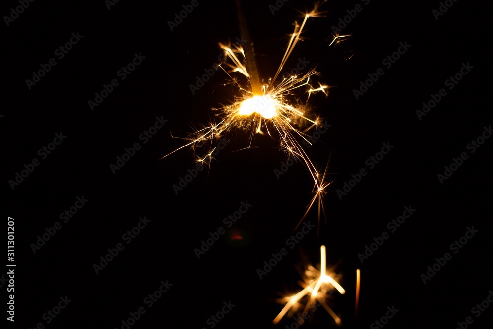 Close-Up Of Illuminated Sparklers At Night