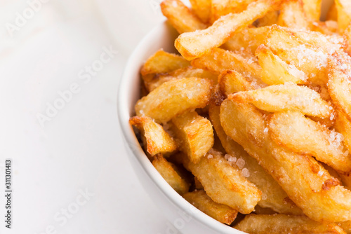 Bowl of potatoe fries on a white background