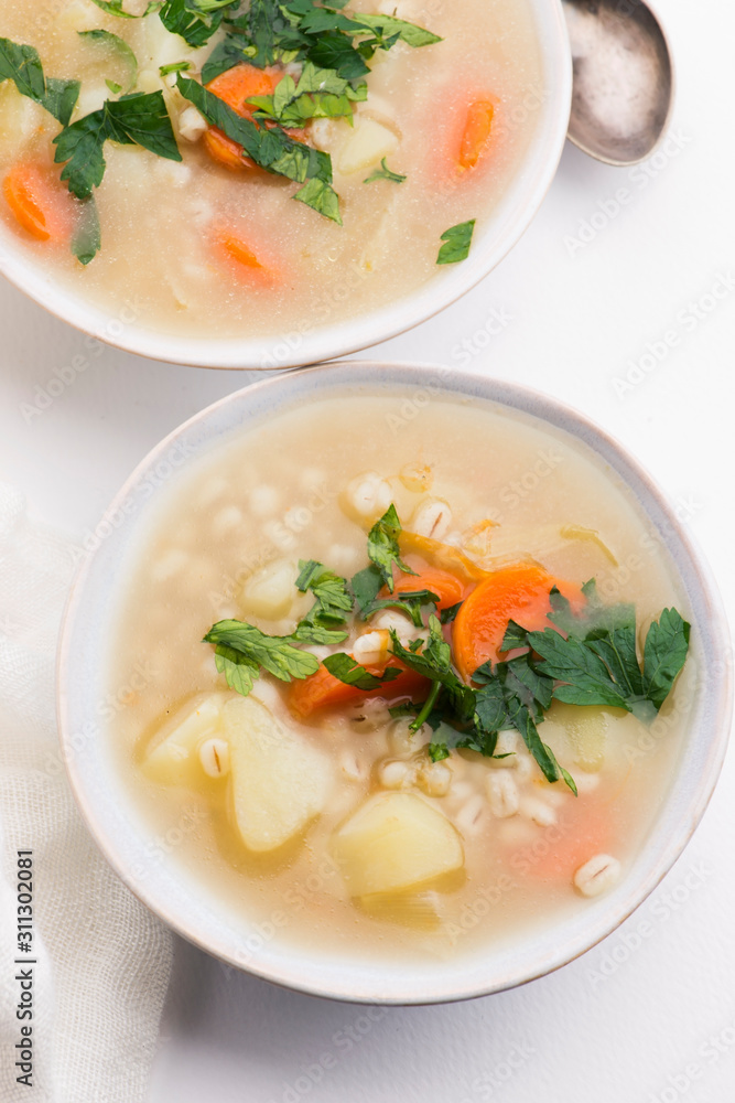 Barley soup, pearl barley in white bowl Barley soup, pearl barley in white bowl
