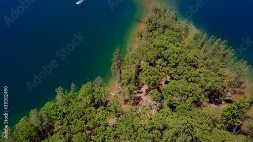 Whiskeytown Lake California - Island Covered With Forest Green Trees With Beautiful Crystal Clear Green Coastline - Aerial Shot photo