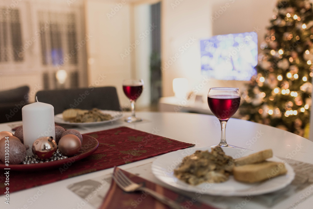 christmas dinner table with meal on plate and glass of wine christmas dinner table with meal on plate and glass of wine
