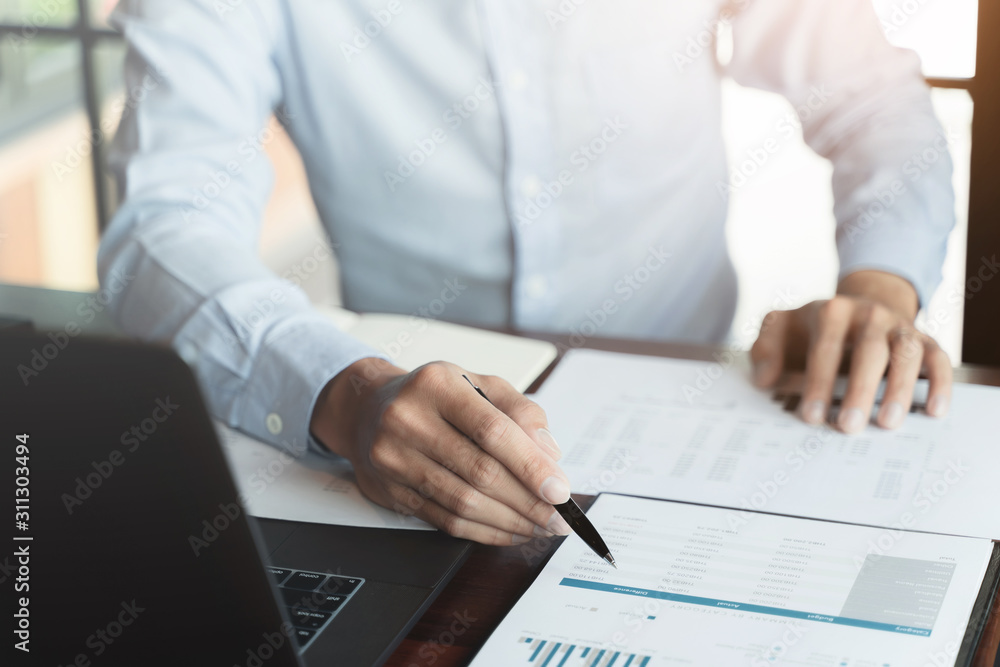 Business executive calculating a sales data perform spreadsheets. Business executive calculating a sales data perform spreadsheets.