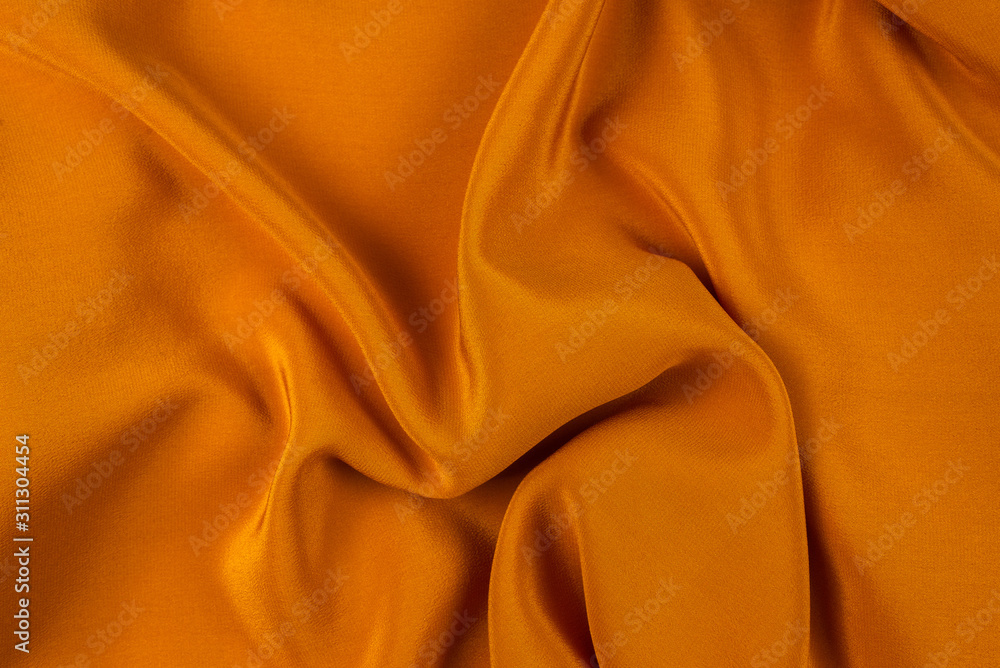 Golden silk or satin luxury fabric texture can use as abstract background. Golden silk or satin luxury fabric texture can use as abstract background.