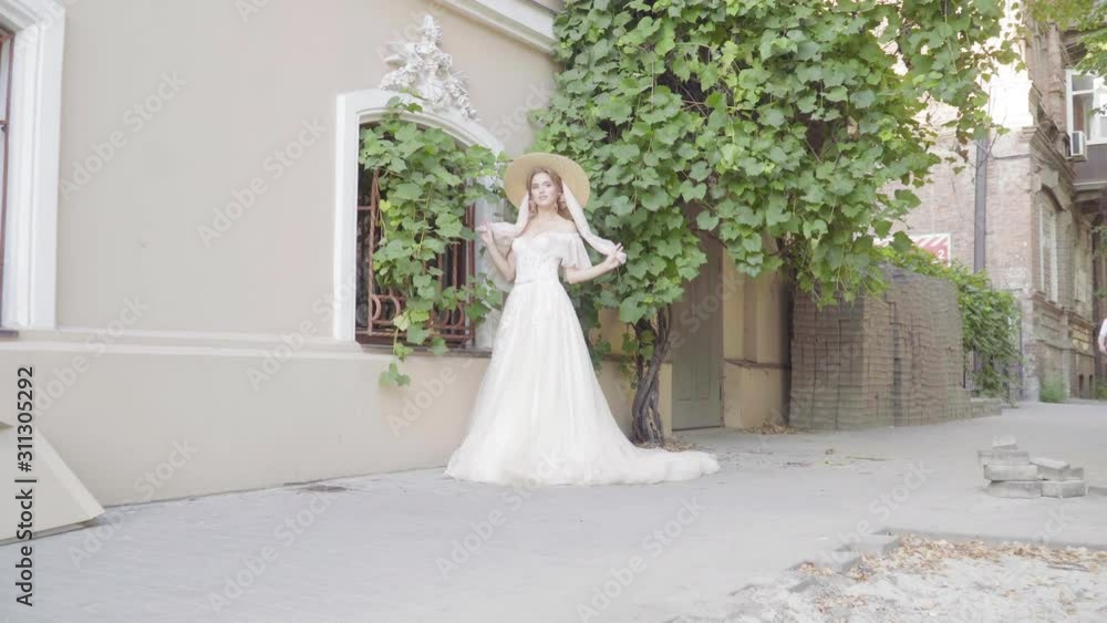 Beautiful girl in a wedding dress near growing grapes Beautiful girl in a wedding dress near growing grapes