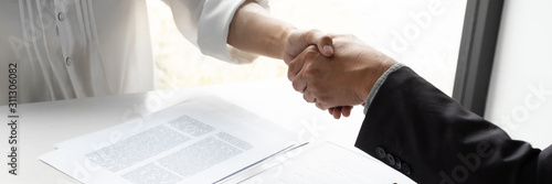 Lawyer and client handshake with contract agreement signing in law firm. photo