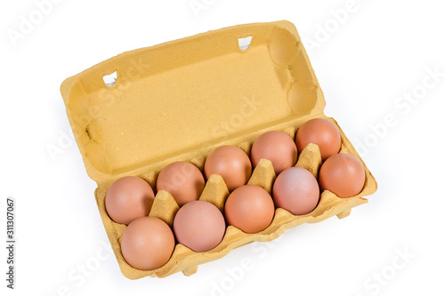 Chicken eggs in open cardboard tray on a white background