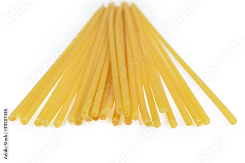 Uncooked long tubular pasta close-up in selective focus photo