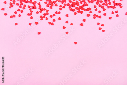 Pink background with red hearts. Valentine's day concept. Top view. Copy space for text.