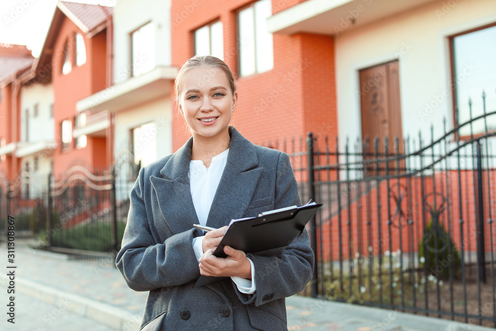 Fototapeta premium Female real estate agent outdoors