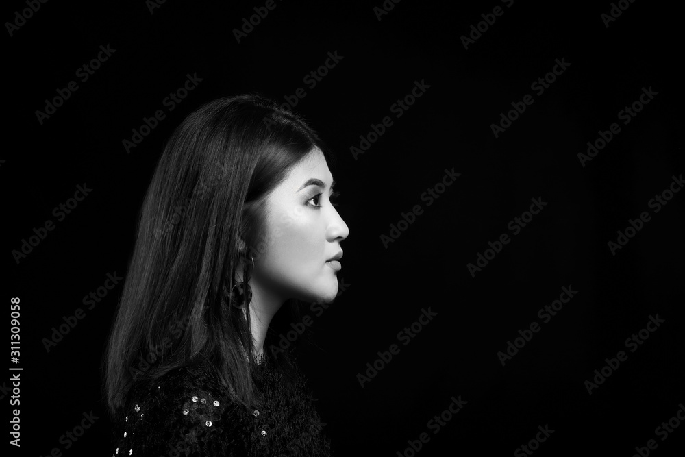Black and white portrait of young Asian woman on dark background Black and white portrait of young Asian woman on dark background