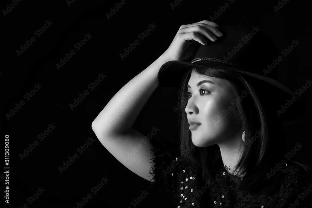 Black and white portrait of young Asian woman on dark background Black and white portrait of young Asian woman on dark background