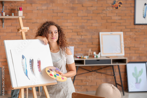 Young Female Artist Paintin...