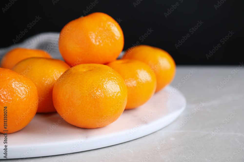 Fresh ripe tangerines on light grey table, closeup. Space for text Fresh ripe tangerines on light grey table, closeup. Space for text
