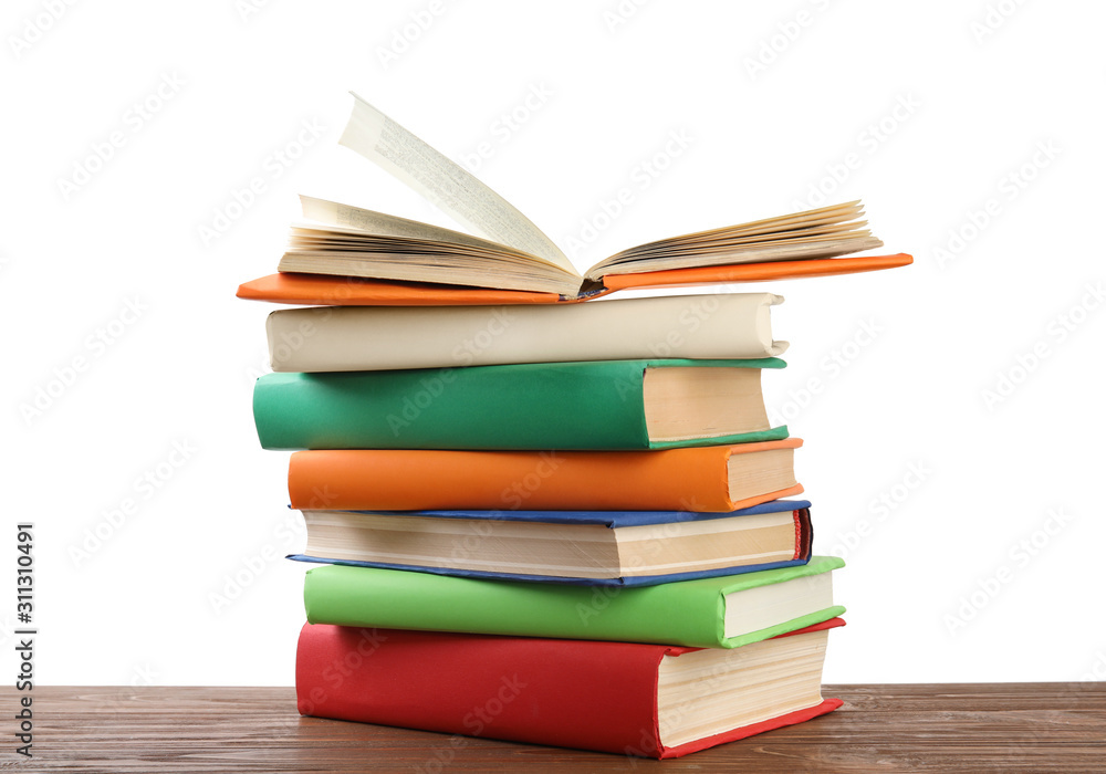 Stack of colorful books on wooden table against white background Stack of colorful books on wooden table against white background