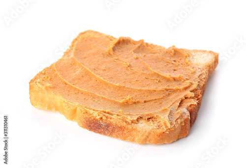 Toasted bread with tasty peanut butter on white background