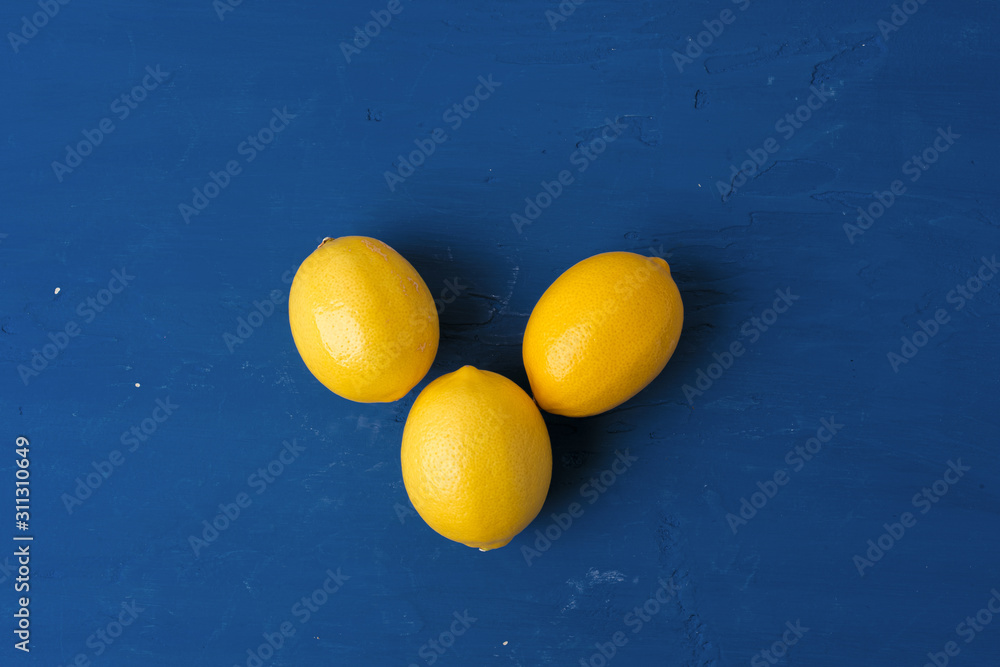 Lemon on classic blue background, top view Lemon on classic blue background, top view