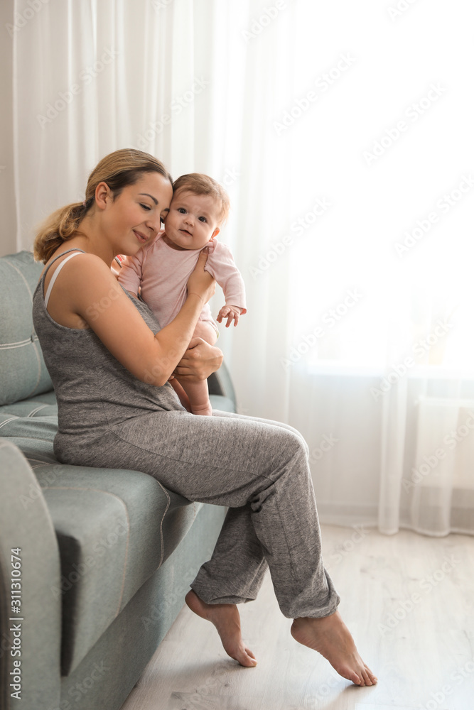 Young woman with her cute baby at home Young woman with her cute baby at home