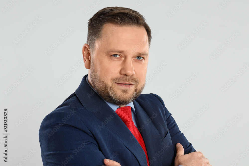 Portrait of happy mature man on light grey background Portrait of happy mature man on light grey background