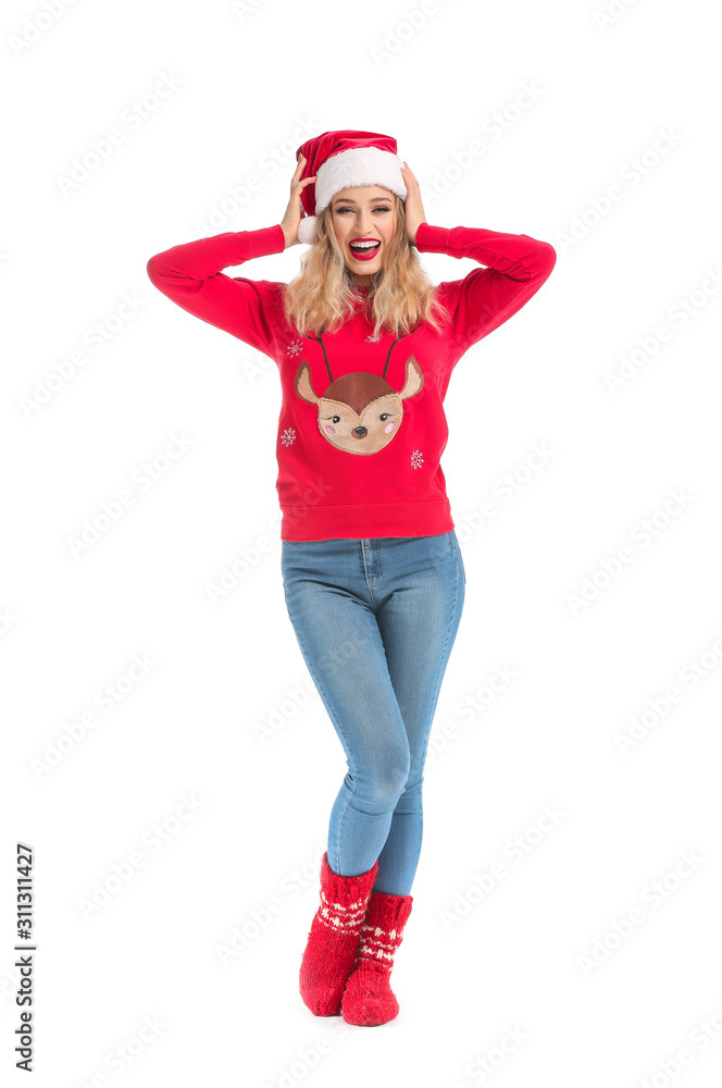 Beautiful young woman in Santa hat and Christmas clothes on white background Beautiful young woman in Santa hat and Christmas clothes on white background