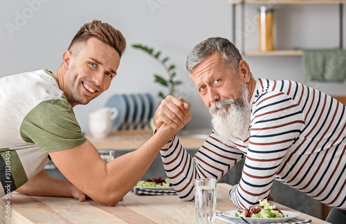 Senior man and his adult so...