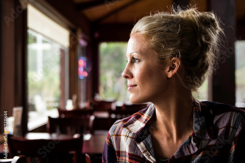 a beautiful young woman looking to the side at a restaurant