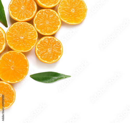 Composition with halves of fresh ripe tangerines and leaves on white background  top view. Citrus fruit