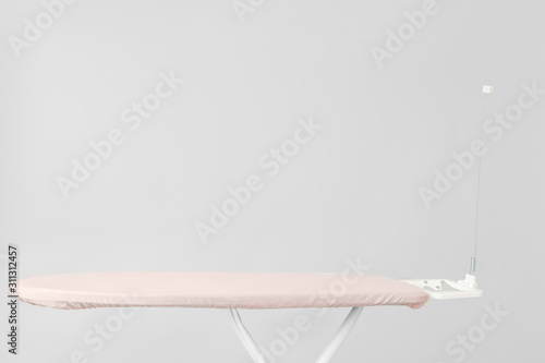 Empty ironing board with pi...