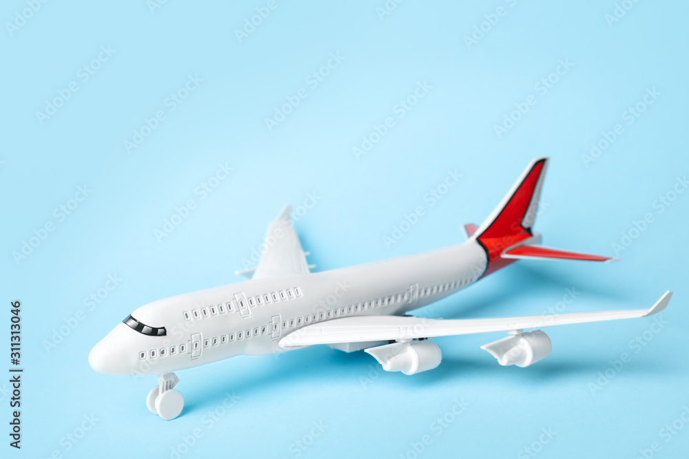 Toy plane on blue background. Logistics and wholesale concept