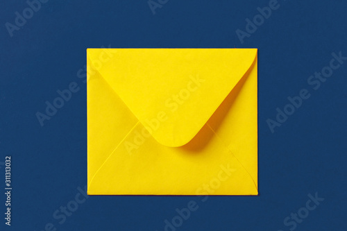 Paper yellow envelope on a blue colored background