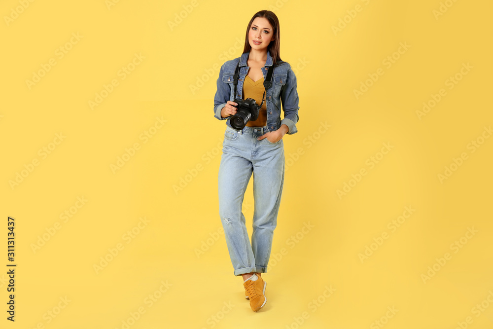 Professional photographer working on yellow background in studio Professional photographer working on yellow background in studio