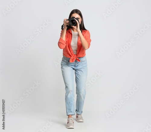 Professional photographer working on white background in studio