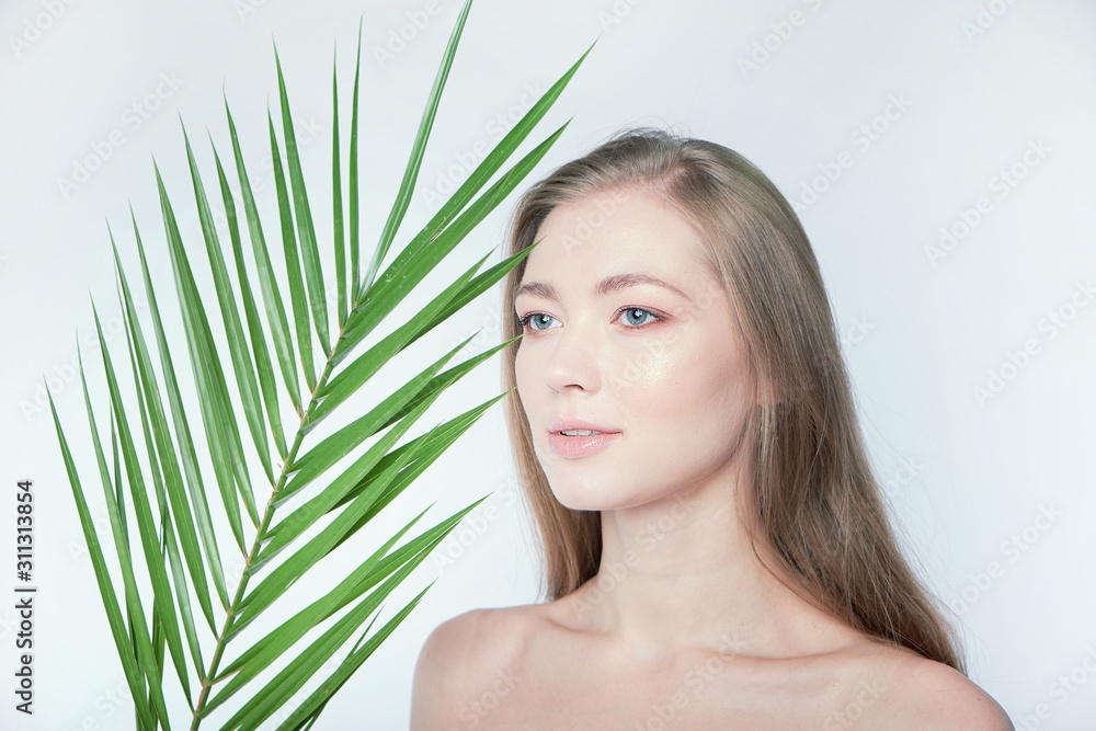 Natural organic skin care, the concept of harmony with nature, green long fern leaves grass near the face. portrait of beauty ladies. Young beautiful woman with clean sparkling skin of face and body. Natural organic skin care, the concept of harmony with nature, green long fern leaves grass near the face. portrait of beauty ladies. Young beautiful woman with clean sparkling skin of face and body.