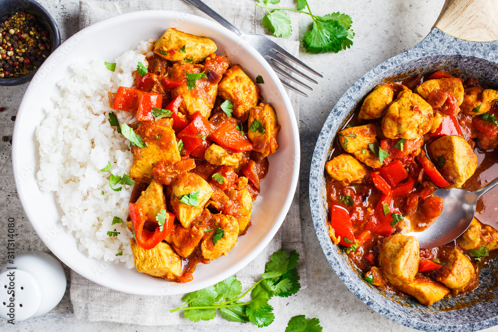 Jalfrezi chicken with rice in white bowl, top view. Traditional indian cuisine concept. Jalfrezi chicken with rice in white bowl, top view. Traditional indian cuisine concept.