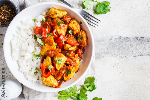 Bild auf Leinwand Jalfrezi chicken with rice in white bowl, top view, copy space