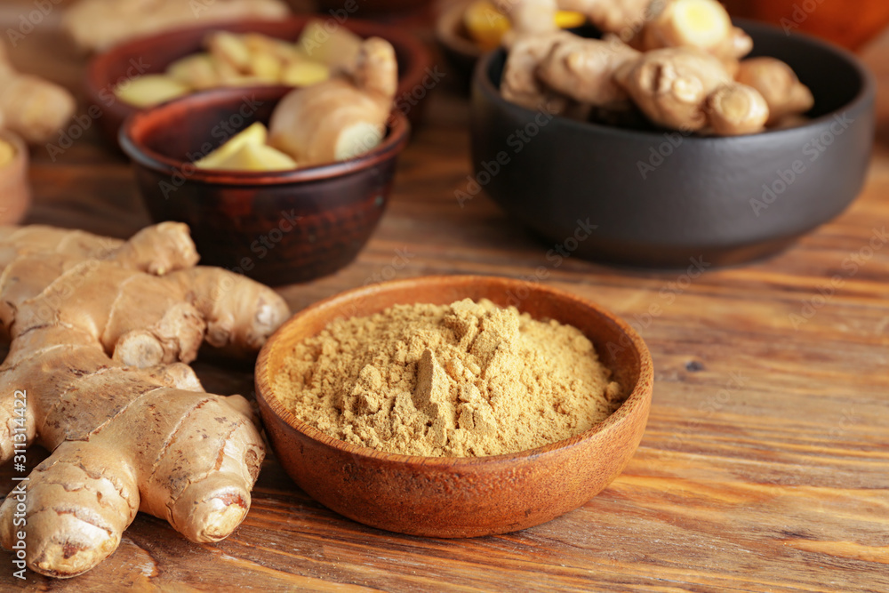 Fresh and ground ginger on wooden table Fresh and ground ginger on wooden table