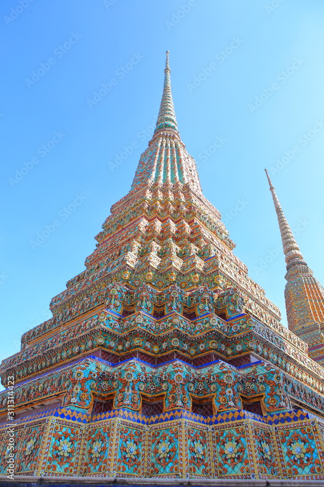 Phra Maha Chedi Si Rajakarn,This is a group of four large stupas, each 42 metres high,These four chedis are dedicated to the first four Chakri kings,Ornamental tile