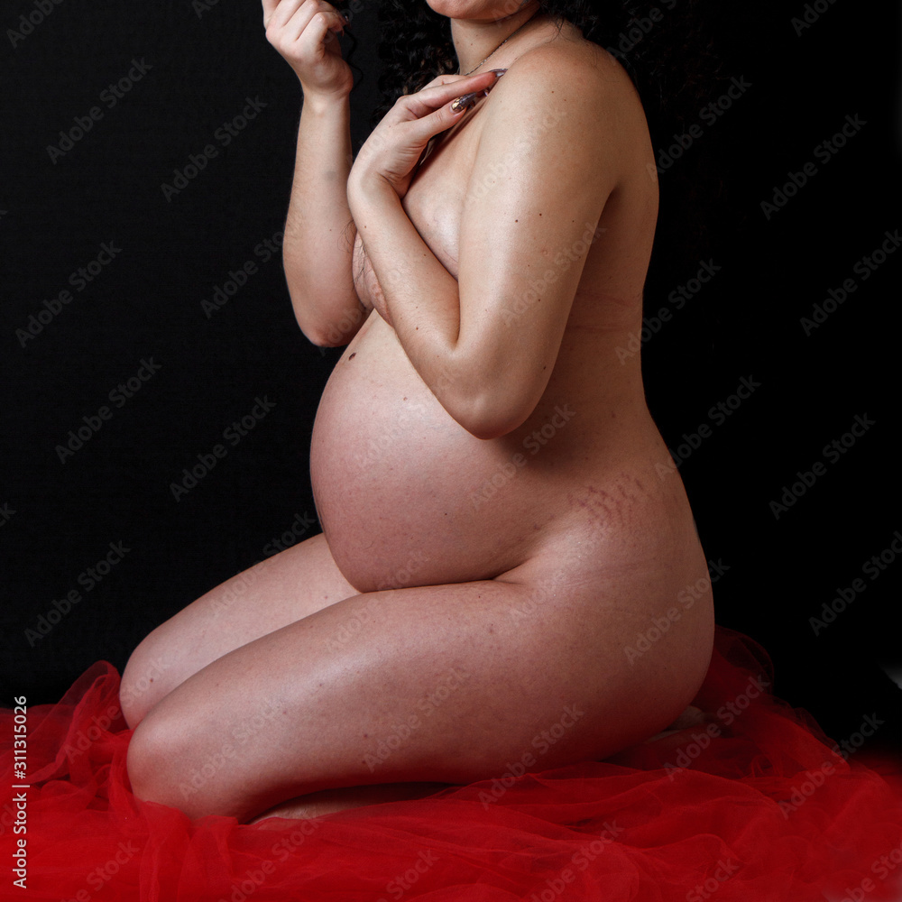 naked pregnant woman shows the changes that have occurred to the body during pregnancy photo image
