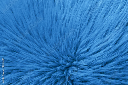 Faux fur as background, top view. Color of the year 2020 (Classic blue)