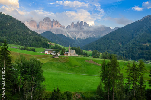 The Odle mountain peaks and the church of Santa Maddalena, Val di Funes valley. Picturesque. Alpe di Siusi or Seiser Alm with Sassolungo and Langkofel mountain group, South Tyrol, Italy