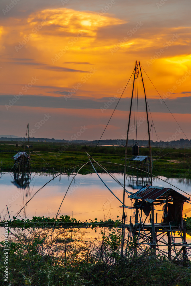 Traditional fishing tool or bamboo fish trap on sunset light, landscape silhouette. Traditional fishing tool or bamboo fish trap on sunset light, landscape silhouette.