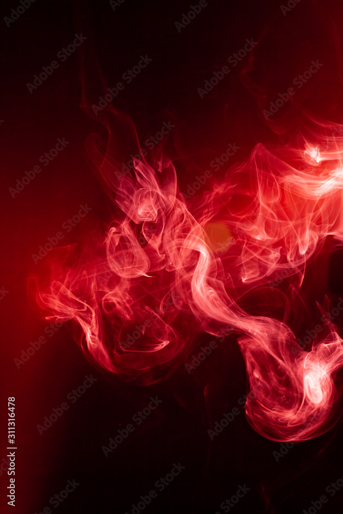 Fototapeta premium Red smoke motion on black background.